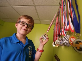 Seven-year-old Grayson Powell shows off his bowling and other sporting medals at home in Conception Bay South, N.L. on Wednesday, March 1, 2017.