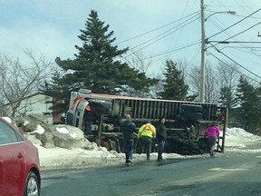 People look on as a truck lies on its side in Paradise, N.L. on Saturday, March 11, 2017