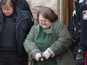 Elizabeth Wettlaufer is escorted from the courthouse in Woodstock, Ont., on Friday, Jan. 13, 2017.