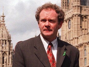 In this May 13, 1997 file photo Sinn Fein's Martin McGuinness walks past the Houses of Parliament in London