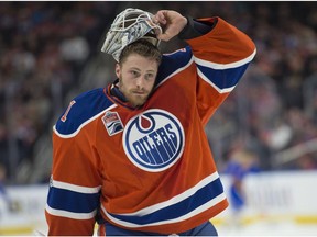 Edmonton Oilers goalie Laurent Brossoit lifts his mask against the Chicago Blackhawks on Feb. 11.