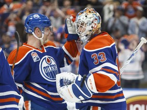 Matt Hendricks, left, congratulates goaltender Cam Talbot after a 2-0 win by the Edmonton Oilers over the Los Angeles Kings in NHL action Monday night in Edmonton. Talbot had 35 saves in posting his second straight shutout and fourth straight victory.