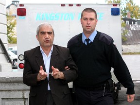 Kingston Police special constable Brian Hackett brings Mohammed Shafia of Montreal into county court in Kingston on Tuesday October 5th 2010 for the beginning of a preliminary hearing into the murder of three daughters of the Shafia family as well as Mohammed Shafia's ex-wife. The four women were found inside a submerged car in the Kingston Mills Locks on the Rideau Canal in June of 2009.