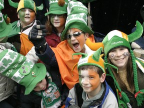 Kids decked out in their Irish finery take in the floats during the 2004 St. Patrick's Day Parade in Toronto.