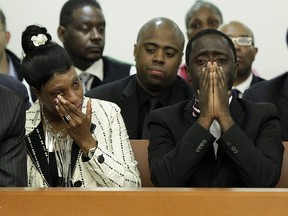 In this June 13, 2012 file photo, Constance Malcolm and Frank Graham, parents of 18-year-old Ramarley Graham, weep during the arraignment of Officer Richard Haste, in Bronx Supreme Court, in the Bronx borough of New York.