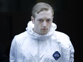 James Harris Jackson is escorted out of a police precinct in New York, Wednesday, March 22, 2017. Police said Jackson, accused of fatally stabbing a black man in New York City, told investigators he traveled from Baltimore specifically to attack black people.