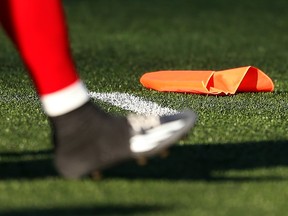 In this July 18, 2015 file photo, a penalty flag lies on the turf during a Calgary Stampeders-Winnipeg Blue Bombers game in Calgary.
