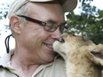 Michael Hackenberger with an African lion cub at the Bowmanville Zoo on Thursday, July 31, 2014