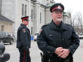 Kingston Police Const. Jim Lindsay stands in front of the Frontenac County Court House on Jan. 26 2012 after a bomb threat was sent in during the Shafia family murder trial  on Thursday July 23 2015 Lindsay was charged by the Ontario Special Investigations unit with nine sex charges from complaints in the 1980's.