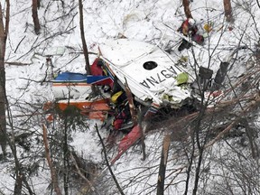 Rescuers work near the helicopter crashed in mountains in Nagano prefecture, central Japan Sunday, March 5, 2017.