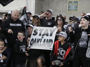 Oakland Raiders fans gather for a picture before the start of a rally to keep the team from moving Saturday, March 25, 2017, in Oakland, Calif.