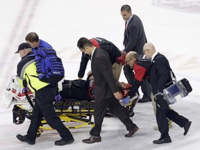 Carolina Hurricanes goalie Eddie Lack, of Sweden, is removed from the ice following an injury during overtime in an NHL hockey game against the Detroit Red Wings in Raleigh, N.C., Monday, March 27, 2017.