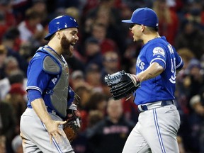 Toronto Blue Jays' Roberto Osuna, right, and Russell Martin celebrate after defeating the Boston Red Sox 2-1 during a baseball game in Boston, Sunday, Oct. 2, 2016.