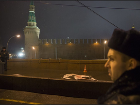 In this Saturday, Feb. 28, 2015 file photo, Russian police officers stand next to the scene where Boris Nemtsov, a former Russian deputy prime minister and opposition leader, was killed at Red Square