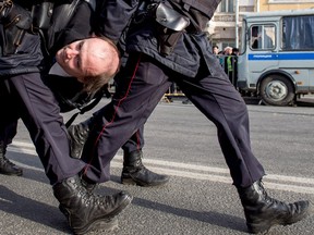 Police officers detain a man during an unauthorized anti-corruption rally in central Moscow on March 26, 2017. Thousands of Russians demonstrated across the country on to protest at corruption, defying bans on rallies.
