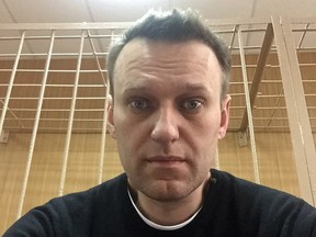 In this handout photo provided by Alexei Navalny, the Russian opposition leader takes a selfie inside a court room in Moscow, Russia, Monday, March 27, 2017.