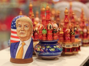 A martyoshka doll showing Donald Trump, sits beside painted wooden models of St. Basil's cathedral in a souvenir store in Moscow, Russia, Nov. 9, 2016