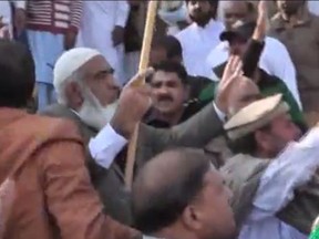 Rashid Ahmed of Mississauga, Ont, in white cap, can be seen in videos of the Dec. 12 attack on a minority Ahmadiyya mosque in Chakwal, Pakistan.