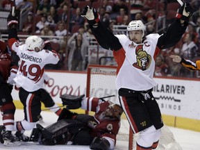 Ottawa Senators defenceman Erik Karlsson (right) celebrates after scoring against the Arizona Coyotes on March 9.