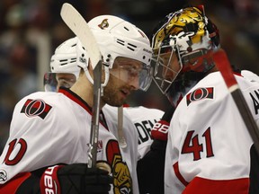 Tom Pyatt congratulates Ottawa Senators goalie Craig Anderson after stopping the Colorado Avalanche in the third period of their game Saturday night in Denver.