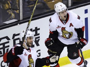 Kyle Turris, right, celebrates after his go-ahead goal with Ottawa Senators teammate Derick Brassard against the Bruins during the third period of of their game in Boston on Tuesday night.