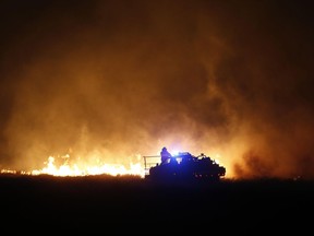 Firefighters from across Kansas and Oklahoma battle a wildfire near Protection, Kan., Monday, March 6, 2017