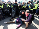 An injured supporter of South Korean President Park Geun-hye lies on the ground during a rally opposing her impeachment in Seoul, South Korea, Friday, March 10, 2017.