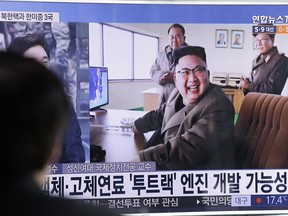 A man watches a TV news program showing an image, published in North Korea's Rodong Sinmun newspaper, of North Korean leader Kim Jong Un at the country's Sohae launch site, at Seoul Railway station in Seoul, South Korea, Sunday, March 19, 2017.