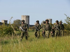 This picture taken on September 14, 2016 shows Swedish military patrolling outside Visby, on Gotland island, Sweden