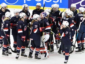In this March 28, 2015 file photo, U.S players celebrate after beating Canada at the women's world hockey championships in Malmo, Sweden.