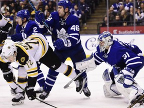 Boston Bruins' Frank Valrano gets knocked down from behind by Toronto Maple Leafs' defenceman Roman Polak during NHL action Monday night in Toronto. Leafs' goaltender Frederik Andersen remains focused on what's going on with the puck carrier. Andersen stood tall with 31 saves as the Leafs posted a 4-2 victory to solidify their hold on a wild card spot in the Eastern Conference.