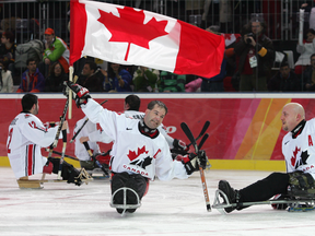 Canadian sledge hockey captain Todd Nicholson (centre), now Canada's chef de mission for the 2018 Paralympics in PyeongChang, celebrates the gold-medal goal at the 2006 Paralympics in Turin, Italy.
