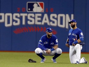 In this Oct. 18, 2016 file photo, Toronto Blue Jays outfielders Kevin Pillar and Jose Bautista wait during a pitching change in Game 4 of the ALCS against Cleveland.