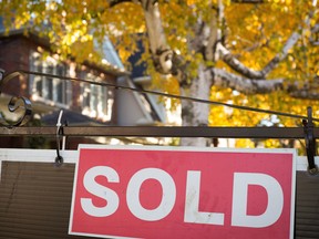 A real estate sold sign hangs in front of a west-end Toronto property Friday, Nov. 4, 2016. THE CANADIAN PRESS/Graeme Roy ORG XMIT: CPT116