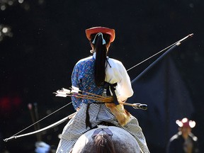 An archer from the Takeda School of Horseback Archery practices before a Yabusame archery demonstration on the grounds of the Meiji Shrine in Tokyo.