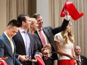 Joo Kim Tiah, CEO of the Holborn Group; Donald Trump Jr., his wife Vanessa Haydon, Eric Trump, and his wife Lara Yunaska prepare for the ribbon cutting ceremony