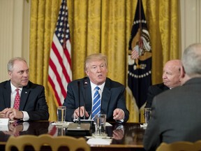 President Donald Trump, flanked by House Majority Whip Steve Scalise of La., left, and House Ways and Means Committee Chairman Rep. Kevin Brady, R-Texas, speaks during a meeting in the East Room of the White House in Washington, Tuesday, March 7, 2017, with the House Deputy Whip team.