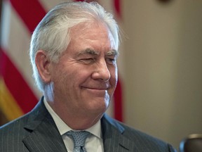 Secretary of State Rex Tillerson smiles as President Donald Trump speaks during a Cabinet meeting in the White House on Monday, March 13, 2017.