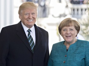 U.S. President Donald Trump and Angela Merkel, Germany's chancellor, smile for photographs as she arrives to the West Wing of the White House in Washington, D.C., U.S., on Friday, March 17, 2017