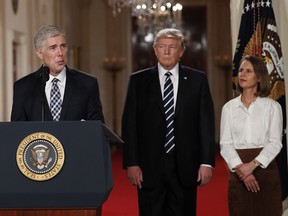 Judge Neil Gorsuch speaks as his wife Louise and President Donald Trump stand with him on stage in East Room of the White House in Washington, Tuesday, Jan. 31, 2017, after the president announced Judge Neil Gorsuch as his nominee for the Supreme Court.