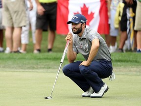 Adam Hadwin lines up a putt on the second green in front of a Canadian flag during the final round of the Valspar Championship at Innisbrook Resort Copperhead Course on March 12 in Palm Harbor, Florida.