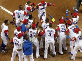 Dominican Republic players celebrate a Nelson Cruz home run in a game against the United States on March 11.