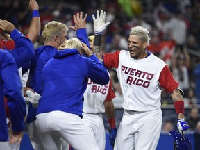 Yadier Molina of Puerto Rico, right, is congratulated  after hitting a solo home run during the sixth inning of the World Baseball Classic second-round game between against the Dominican Republic at Petco Park in San Diego on March 14, 2017.