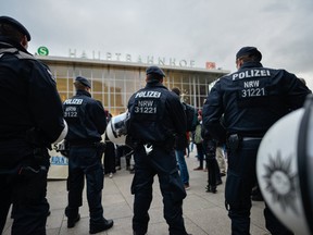 Police stand guard as supporters of Pro NRW, a right-wing, populist group, protest the New Year's Eve sex attacks