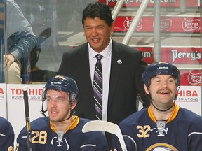 In this Nov. 15, 2013 file photo, Ted Nolan smiles on the Buffalo Sabres bench.