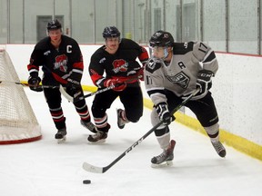 In this Nov. 26, 2016 file photo, Beaverlodge Blades forwards Davis Isherwood and Evan Tordiff defend against Grande Prairie Kings forward Kelsey Bauman in a North West Junior Hockey League game.