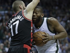 Milwaukee Bucks' Greg Monroe is stopped by Toronto Raptors' Jonas Valanciunas during the second half of Game 4 of an NBA first-round playoff series basketball game on Saturday, April 22, 2017, in Milwaukee.