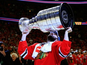 In this June 15, 2015 file photo, Chicago Blackhawks goalie Corey Crawford lifts the Stanley Cup.