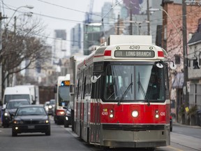 The TTC 501 streetcar makes its way along Queen St. W. in the Parkdale neighbourhood in Toronto, Ont. on Thursday March 2, 2017.