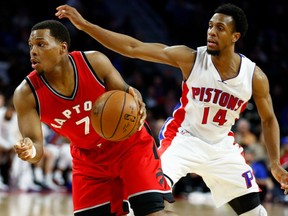 Kyle Lowry of the Toronto Raptors tries to escape the defence of the Pistons' Ish Smith during the first half of their game at the Palace of Auburn Hills in Auburn Hills, Mich., on Wednesday night.